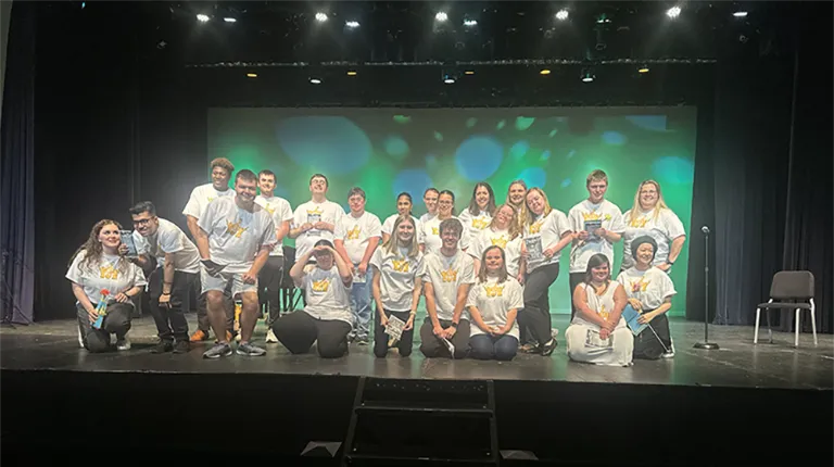 group of soar and strive students on a stage
